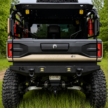 Can-Am Defender HD11 rear bumper with LED lights and frame-mounted tow hooks installed on a 2026 Can-Am Defender. Made in USA by No Limit Wheels.