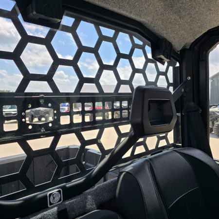 Interior view through Can-Am Defender HD11 Headache Rack showing rear visibility from inside the cab